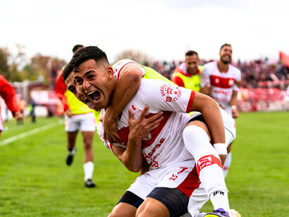 A group of players celebrating, reflecting the joys of the game and the raw emotion that is involved in sports