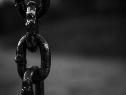 Detailed view of an iron chain's link, ever present memory of a darker past