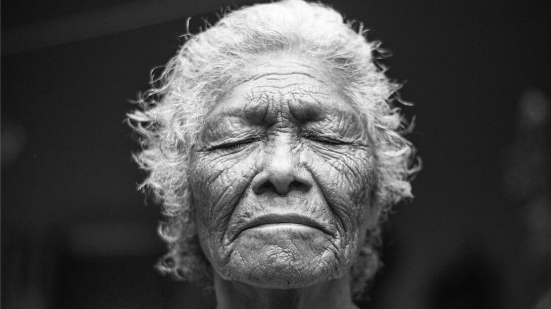 A woman breathes deeply as she reflects on her childhood experiences