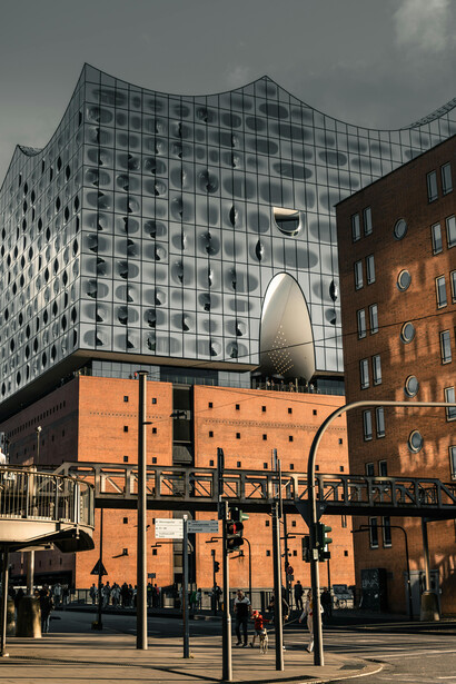 The Elbphilharmonie, or Elphi, is an architectural icon of Hamburg, northern Germany, located in the HafenCity district on the Grasbrook peninsula. Designed to resemble a sail or a shimmering iceberg, it rises from a 20th-century brick warehouse adjacent to the UNESCO-listed Speicherstadt