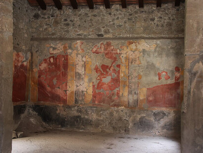 A well-preserved Roman fresco adorns the walls of House I.10.1 in the archaeological site of Pompeii, Italy