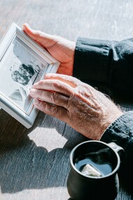 Person holding a photograph 