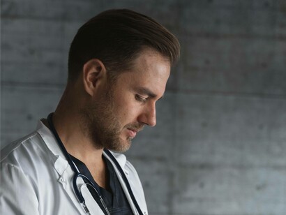 A doctor reading a patient's chart who has an autoimmune disease
