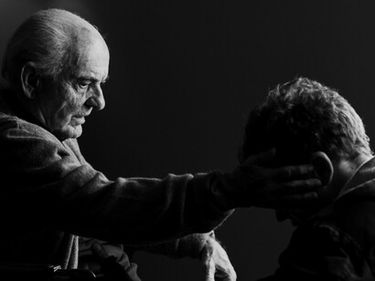 In a moment of profound vulnerability, Mike Flannigan, portrayed by Michael Pitt, sits beside his ailing father, portrayed by Joe Pesci, their silent connection speaking volumes in as they reflect on years of unspoken words and lost time