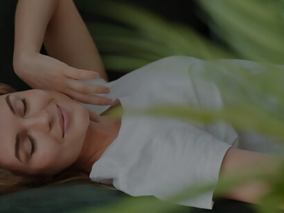 Woman resting on the couch and blurred plant