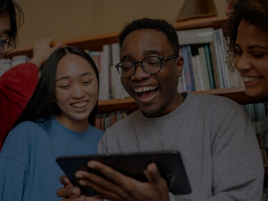 Children in the library, quietly focused on their smartphone activities