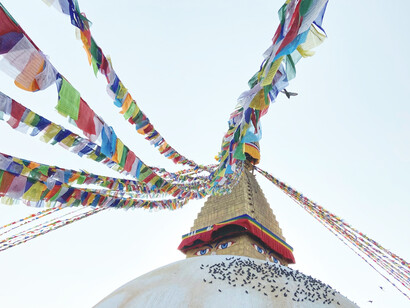 Devotees circle the radiant white dome of Boudhanath in Kathmandu, its painted Buddha eyes watching over them, as they visit nearby monasteries and schools for prayers and spiritual seminars