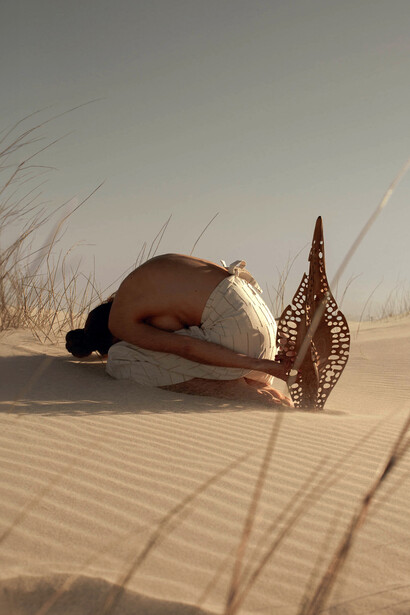 Stillness meeting stillness, Karlien in child’s pose beside ‘Diatom Bokeh’ from the Epiphanic series collaboration with Reticence Studio, photographed by Driaan Claassen