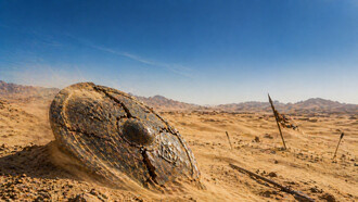 A shattered war relic resting in the desert’s silence, symbolising the end of an era defined by proxy conflict