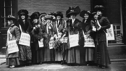 Members of the women's suffrage movement prepare to march on New York's Wall Street in 1913, armed with leaflets and slogans demanding the vote for women