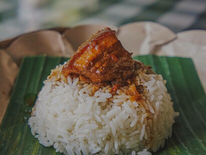 A flavourful piece of meat on bed of rice is a classic African dsih