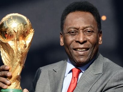 Pelé, Edson Arantes do Nascimento, holding World Fifa Cup, became Sports Minister of Brazil, “The King”
