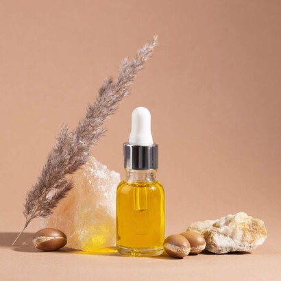 Argan oil, shown here with its raw ingredients, offers deep moisture and protection for fragile coily and texturized hair