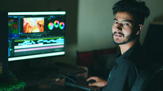 A man focused on editing content while working on his computer