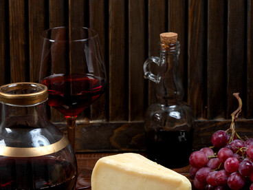 A cheese platter with grapes and wine for perfect pairing