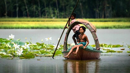 Small boy on a boat, in the Meghna River, in Bangladesh