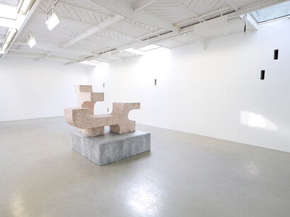 Valentin Carron - Un mur cinq trous, 2014, 5 arrow loopholes, concrete, painting, wood, Variable dimensions - Ravage with granite (after André Tommasini), 2014, Polystyrene and resin, 147 x 162 x 130 cm, View of the exhibition « L’autoroute du soleil à minuit », kamel mennour (47, rue Saint-André des Arts), Paris, 2015 © Valentin Carron, Photo: Fabrice Seixas, Courtesy the artist and kamel mennour, Paris