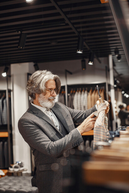 A man inspecting garment and noticing every detail of Loro Piana’s style 
