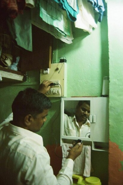 A man looks at his cell phone in Gaondevy