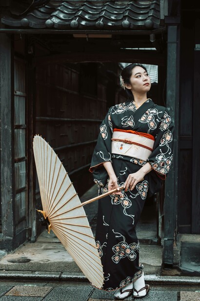 A Japanese woman in a kimono with a parasol, evoking traditional kimono craftsmanship, including pattern layouts, fabric folding, and classic cutting diagram, Kyoto, Japan