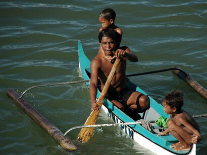 A local fisherman in Mindanao, accompanied by his two young sons, embodies the spirit of hard work and family values that continue to drive the region's growth and prosperity