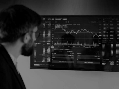A man viewing the latest economic network trends on a screen