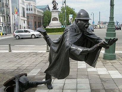 Tom Frantzen, Policeman Being Tripped,1985, is a humorous statue of a policeman being tripped by a man hiding in a sewer manhole. Courtesy the artist