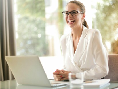 An employee smiling while working, reflecting the loyalty built through participation rather than perks