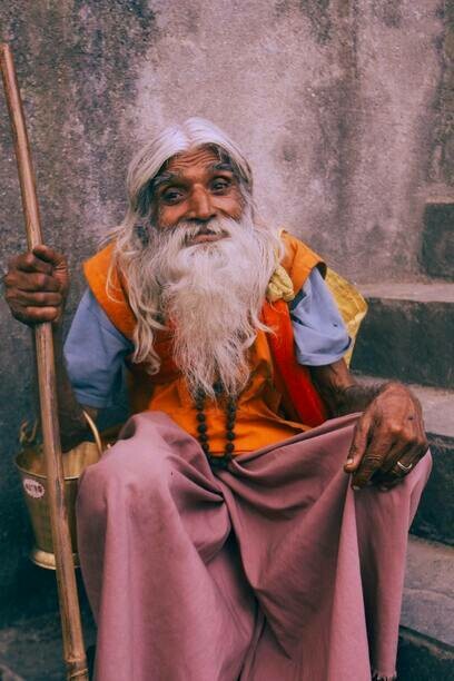 Elderly Monk with a Stick in Varanasi, India