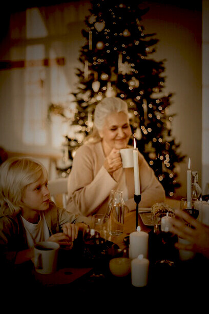 A family comes together around the table, enjoying a warm and joyful Christmas feast