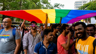 Members and supporters of the lesbian, gay, bisexual, and transgender community, some wearing masks, participate in a Pride March rally in Bangalore, India, on Sunday, November 22, 2015
