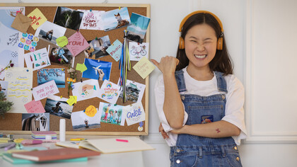 A woman creates a vision board using curated lifestyle images for visual inspiration