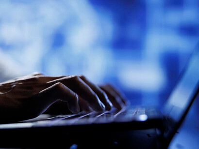 Person at a computer in a low-light setting