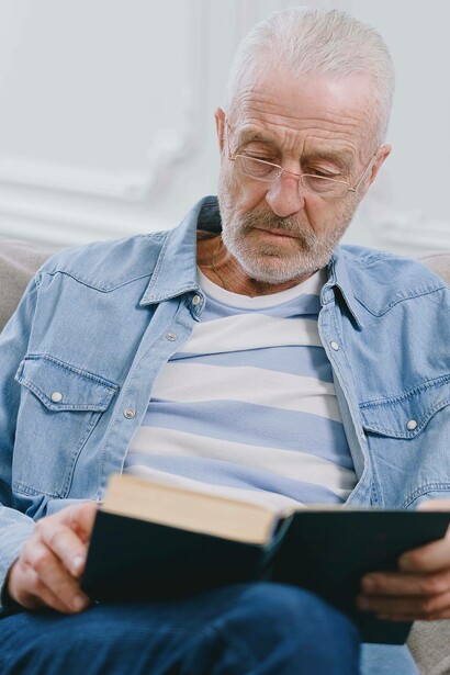 Elderly man reading a book
