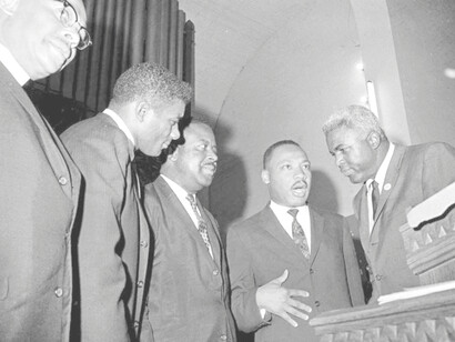 Boxer Floyd Patterson, left, Jackie Robinson, right, Rev. Ralph D. Abernathy, second from left, and Rev. Martin Luther King, Jr., in Birmingham, Ala., May 14, 1963