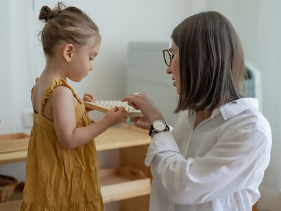 In the enchanting discovery of new toys, a mother and her child engage in a heartwarming exchange, fostering communication and language development