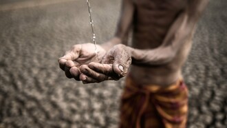 A frail, emaciated man with parched, weathered hands desperately cups a trickle of water against a backdrop of cracked, barren earth—a haunting symbol of extreme drought and deprivation, reflecting the dire consequences of ineffective development aid