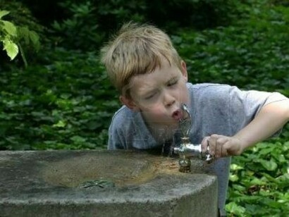 A kid, drinking