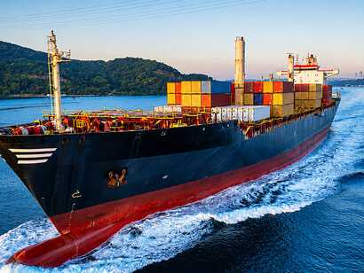 Aerial view of a cargo ship navigating the Bosphorus Strait in Istanbul, a vital maritime trade route connecting Europe, Asia, and the Middle East, Turkey