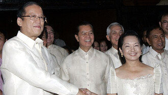 Benigno Simeon Aquino III, the 15th President of the Philippines who served from 2010 to 2016, dons a Barong Tagolog while shaking hands with Gloria Macaraeg Macapagal-Arroyo, the 14th President of the Philippines who served from 2001 to 2010, at Aquino's inauguration at the Malacañang Palace, in Manila, Philippines, on the 30th of June, 2010