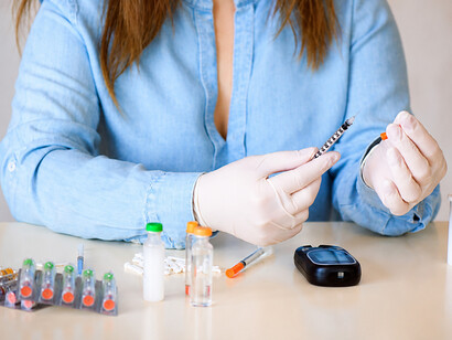 Insulin pen and syringe used for diabetes care in a clinical medical setting
