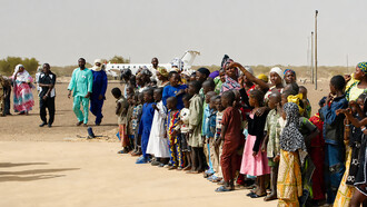 Crowds in Gao, Mali, form a guard of honour for humanitarian workers who arrived by plane in April to assess local needs
