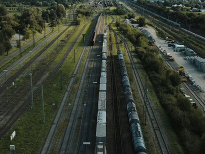 Cargo trains roll through verdant fields, showcasing the arteries of Eurasian trade routes