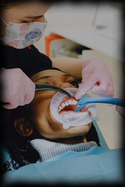 Dentist examines teeth of woman