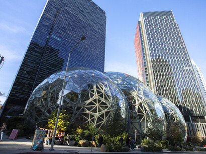 The Amazon Spheres, designed by NBBJ and Site Workshop, are a trio of futuristic glass structures that serve as a botanical retreat within Amazon’s Seattle campus