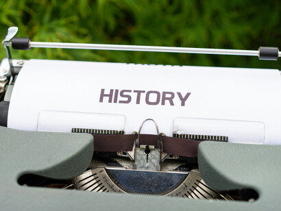 A typewriter typing the words, "history"
