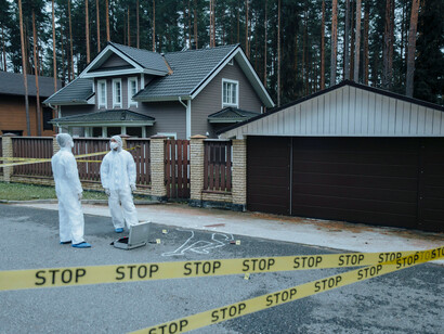 Crime scene investigators conferring while analysing collected evidence