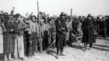 Spanish refugees, mainly republicans and members of the International brigades are guarded by French troops at a camp on Argeles beach in 1939.
