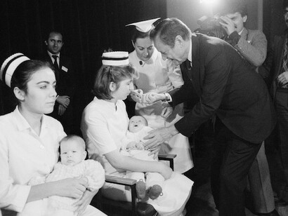 During the final round of a UNICEF-supported immunization campaign in 1985, Jim Grant prepares to administer a dose of oral polio