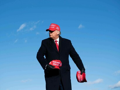 Donald Trump tossing MAGA caps into the crowd